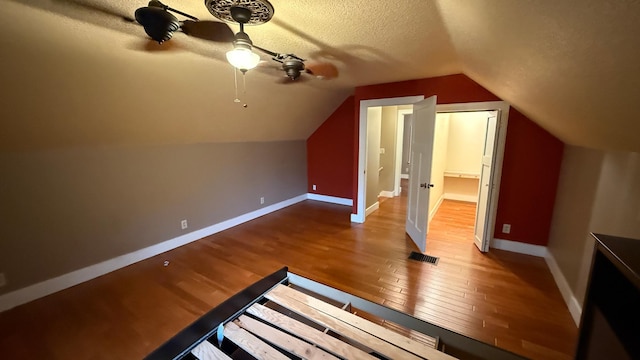 707 11th Ave SE, Rochester, MN 55904 - bonus room featuring wood finished floors, baseboards, ceiling fan, a textured ceiling, and lofted ceiling