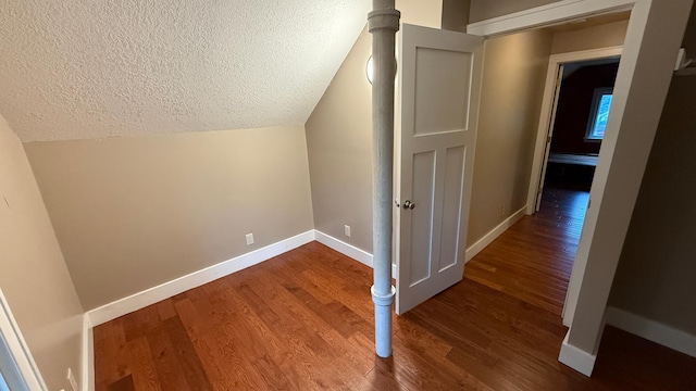 707 11th Ave SE, Rochester, MN 55904 - bonus room with a textured ceiling, wood finished floors, baseboards, and vaulted ceiling