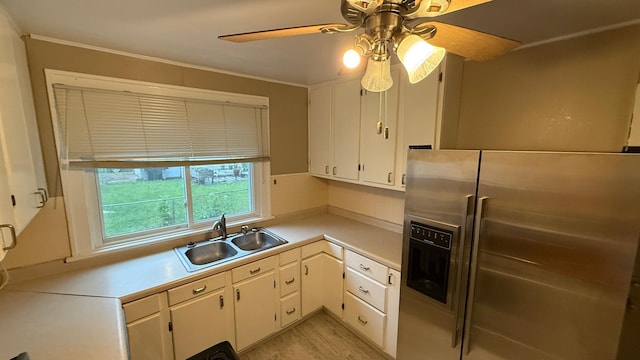 707 11th Ave SE, Rochester, MN 55904 - kitchen with stainless steel fridge, a sink, light countertops, ceiling fan, and white cabinets