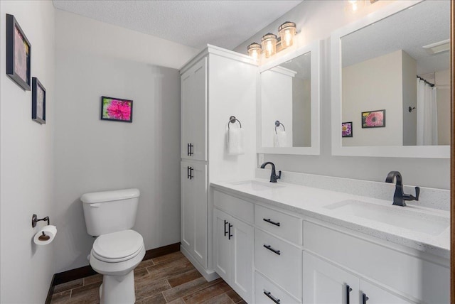 1609 75th Ave, Hammond, WI 54015 - full bath with wood finished floors, double vanity, and a textured ceiling