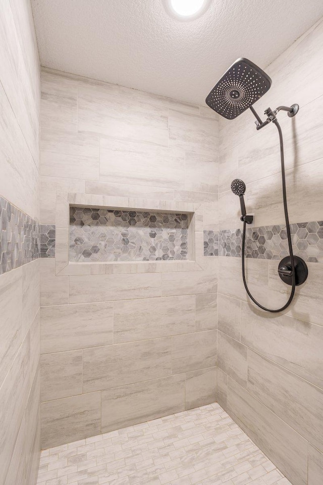 1609 75th Ave, Hammond, WI 54015 - full bathroom with tiled shower and a textured ceiling