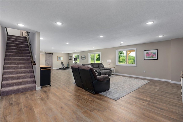 1609 75th Ave, Hammond, WI 54015 - living room featuring stairway, recessed lighting, wood finished floors, and a textured ceiling