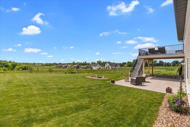 1609 75th Ave, Hammond, WI 54015 - view of green lawn with stairway, a patio area, and a deck