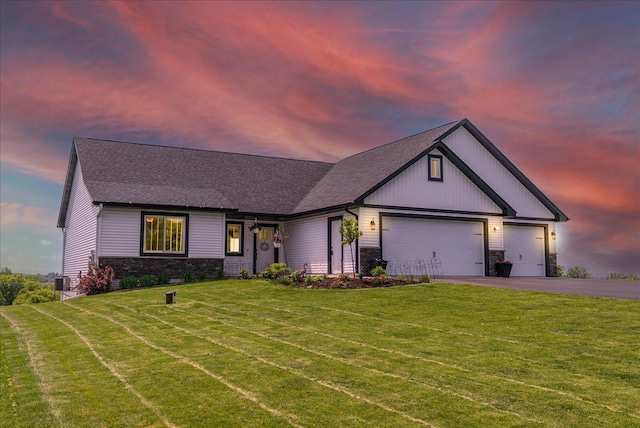 1609 75th Ave, Hammond, WI 54015 - modern farmhouse with stone siding, a garage, a front yard, asphalt driveway, and a shingled roof
