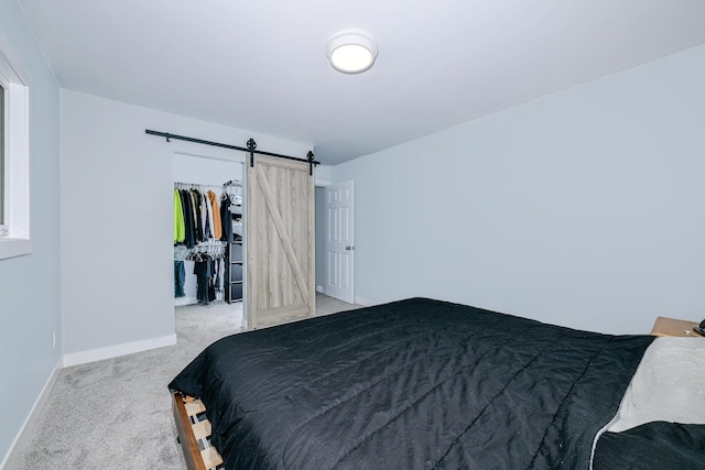 809 Crestwood Dr, Wrenshall, MN 55797 - bedroom with carpet flooring, a barn door, baseboards, a closet, and a spacious closet