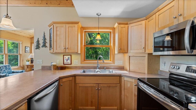 4132 Omaha Ln NW, Alexandria, MN 56308 - kitchen with appliances with stainless steel finishes, light brown cabinetry, hanging light fixtures, a peninsula, and light countertops