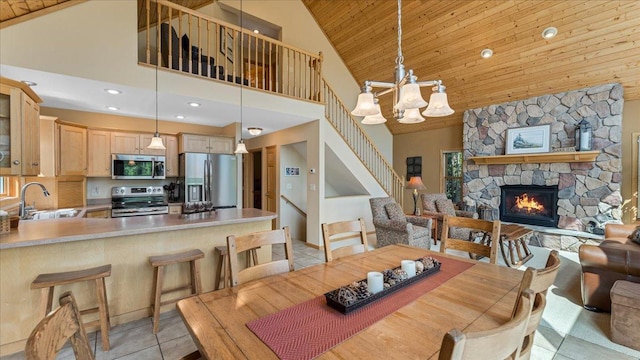 4132 Omaha Ln NW, Alexandria, MN 56308 - dining space with wooden ceiling, stairway, high vaulted ceiling, a fireplace, and a chandelier