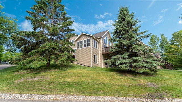 4132 Omaha Ln NW, Alexandria, MN 56308 - view of side of home with a yard and a wooden deck