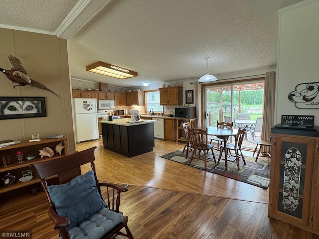 18755 Cassie Ln, Pokegama Twp, MN 55063 - dining space featuring a textured ceiling, light wood-style floors, and ornamental molding