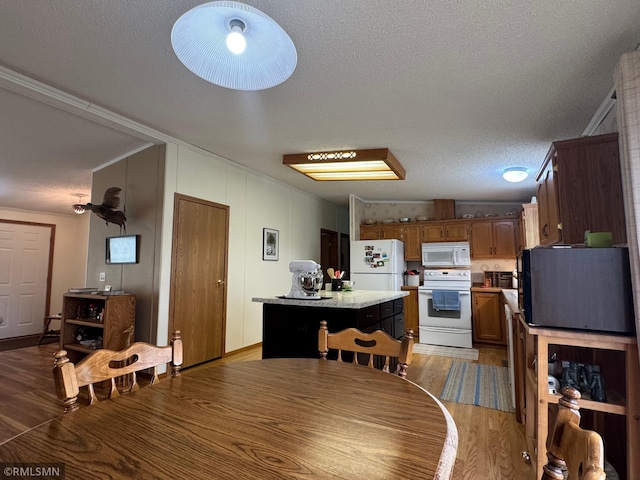 18755 Cassie Ln, Pokegama Twp, MN 55063 - dining area with wood finished floors, a textured ceiling, and ornamental molding