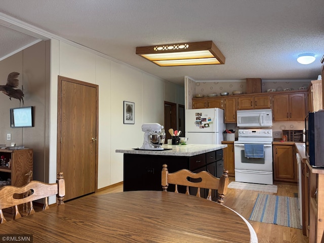 18755 Cassie Ln, Pokegama Twp, MN 55063 - kitchen featuring white appliances, light wood finished floors, light countertops, a kitchen island, and crown molding