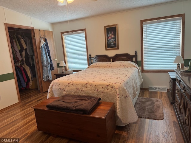 18755 Cassie Ln, Pokegama Twp, MN 55063 - bedroom with wood finished floors, a textured ceiling, a closet, a walk in closet, and ornamental molding