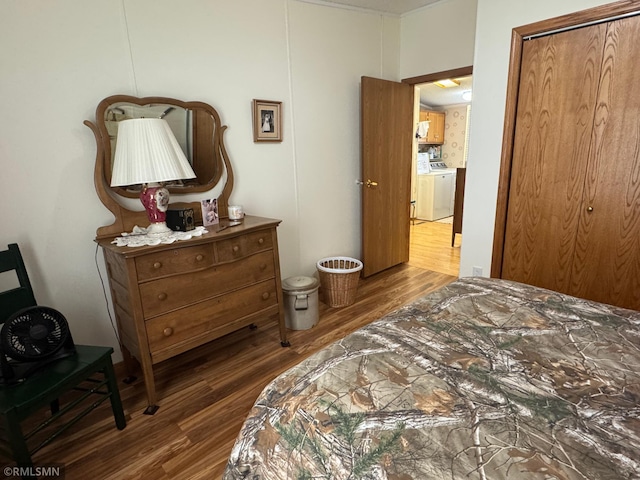 18755 Cassie Ln, Pokegama Twp, MN 55063 - bedroom with wood finished floors, separate washer and dryer, and a closet