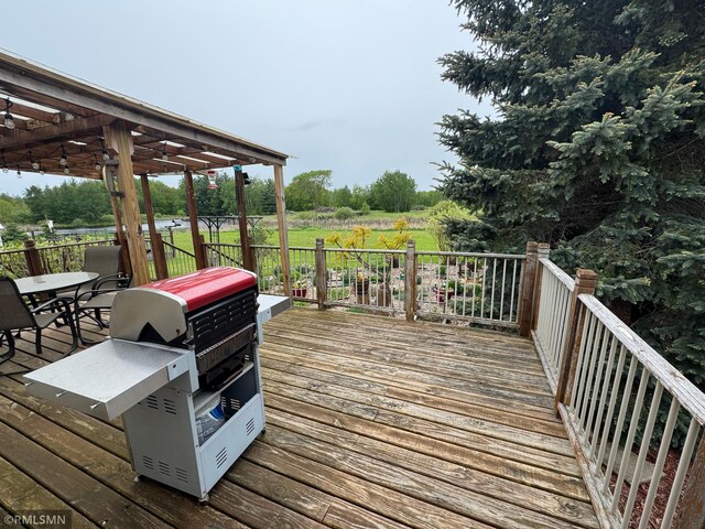 18755 Cassie Ln, Pokegama Twp, MN 55063 - wooden deck with grilling area, a pergola, and outdoor dining space