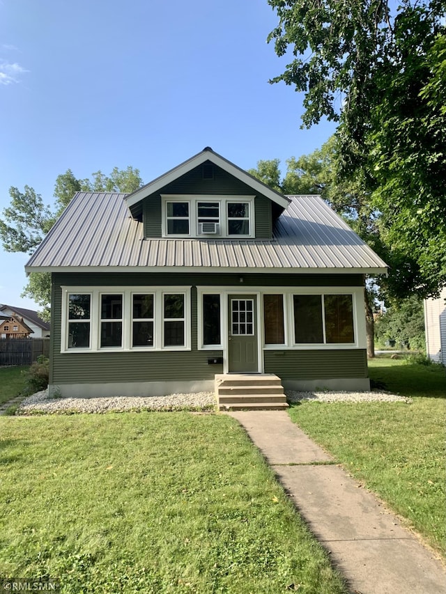 305 7th Ave E, Alexandria, MN 56308 - bungalow-style home with a front yard, metal roof, and entry steps