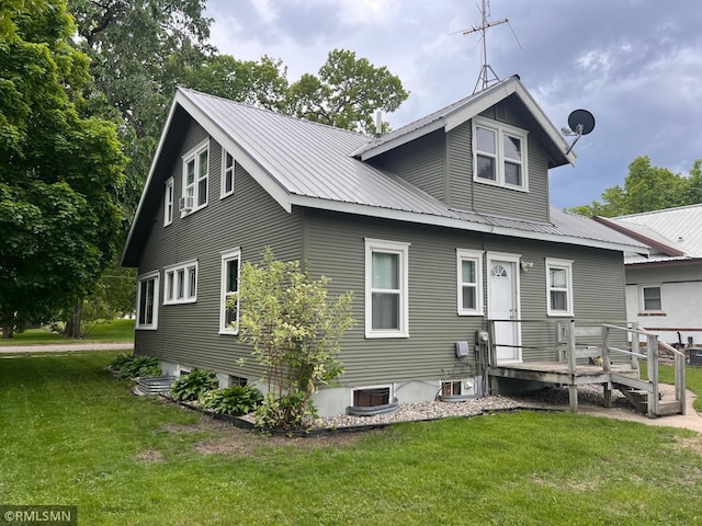 305 7th Ave E, Alexandria, MN 56308 - rear view of property with a lawn, metal roof, a wooden deck, and central air condition unit
