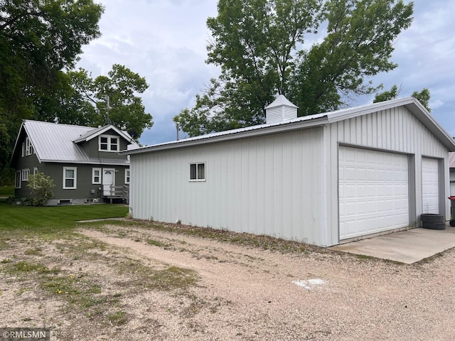 305 7th Ave E, Alexandria, MN 56308 - view of side of property with a detached garage, metal roof, and an outdoor structure