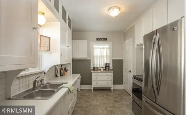 305 7th Ave E, Alexandria, MN 56308 - kitchen featuring stainless steel appliances, white cabinets, decorative backsplash, a sink, and glass insert cabinets