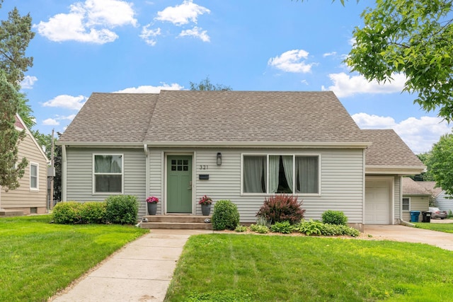 321 15th Ave N, Hopkins, MN 55343 - view of front of property featuring an attached garage, a front yard, a shingled roof, and driveway