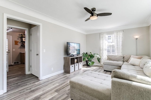 321 15th Ave N, Hopkins, MN 55343 - living room featuring ceiling fan, light wood-style flooring, and crown molding
