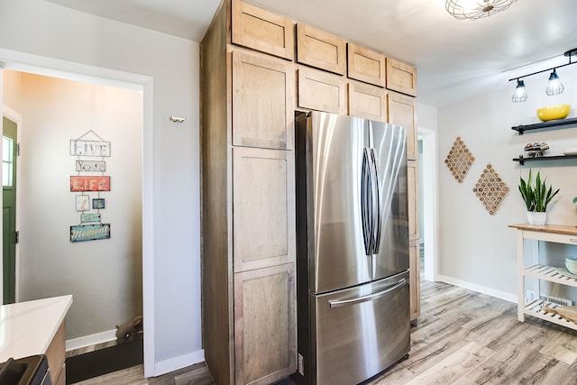 321 15th Ave N, Hopkins, MN 55343 - kitchen featuring freestanding refrigerator, light wood finished floors, light brown cabinets, and open shelves