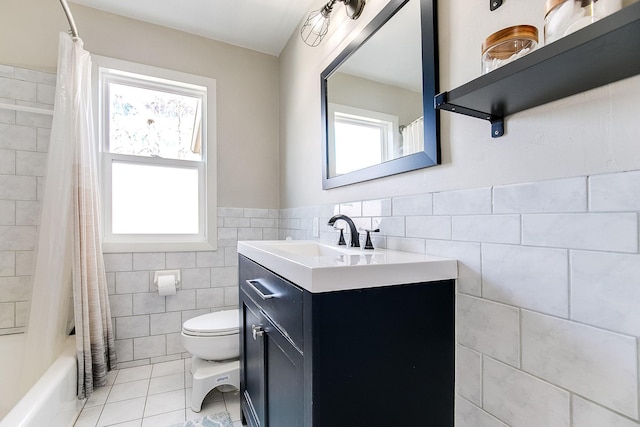 321 15th Ave N, Hopkins, MN 55343 - bathroom featuring tile walls, vanity, tile patterned flooring, shower / bath combination with curtain, and a wainscoted wall