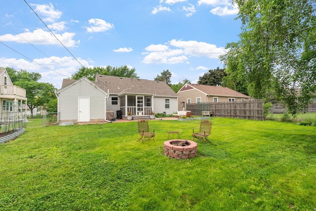 321 15th Ave N, Hopkins, MN 55343 - back of property featuring a fire pit and a sunroom