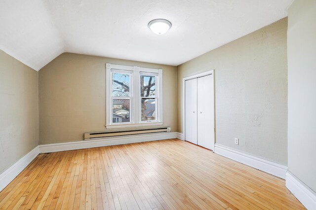 420 Lafond Ave, Saint Paul, MN 55103 - additional living space with a baseboard heating unit, light wood-style floors, baseboards, and vaulted ceiling