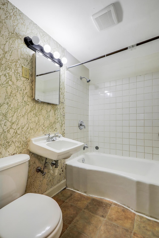 420 Lafond Ave, Saint Paul, MN 55103 - bathroom with toilet, tub / shower combination, wallpapered walls, and a sink