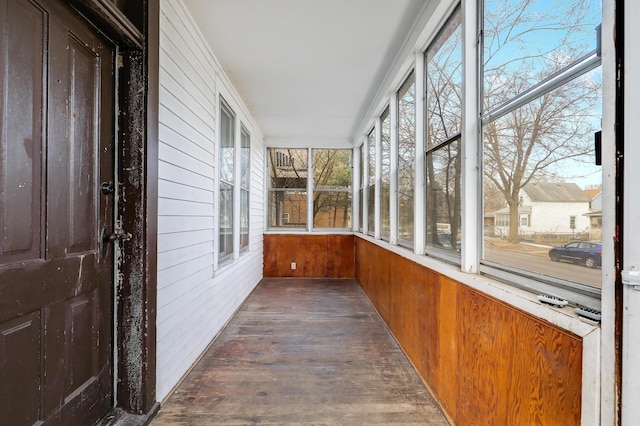 420 Lafond Ave, Saint Paul, MN 55103 - unfurnished sunroom with wood walls, plenty of natural light, and hardwood / wood-style flooring