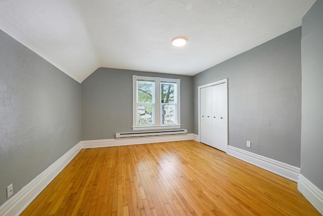 420 Lafond Ave, Saint Paul, MN 55103 - additional living space with baseboard heating, baseboards, light wood finished floors, and lofted ceiling
