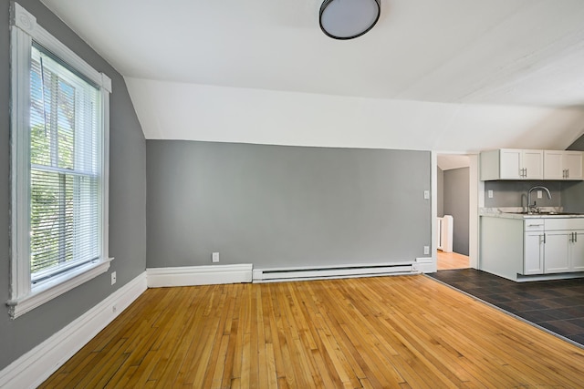 420 Lafond Ave, Saint Paul, MN 55103 - unfurnished living room featuring a baseboard heating unit, a sink, lofted ceiling, wood-type flooring, and baseboards