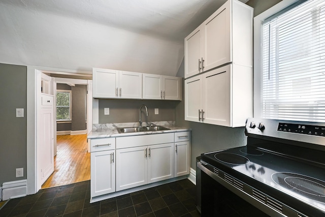 420 Lafond Ave, Saint Paul, MN 55103 - kitchen featuring electric range, a sink, white cabinets, light countertops, and baseboards