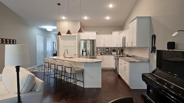 1300 Event Center Dr NE # 23, Bemidji, MN 56601 - kitchen with appliances with stainless steel finishes, light stone counters, backsplash, a sink, and white cabinets