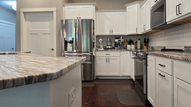 1300 Event Center Dr NE # 23, Bemidji, MN 56601 - kitchen featuring stainless steel appliances, backsplash, white cabinetry, and dark wood-style floors