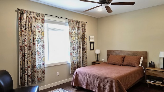 1300 Event Center Dr NE # 23, Bemidji, MN 56601 - bedroom with multiple windows, dark wood finished floors, baseboards, and ceiling fan