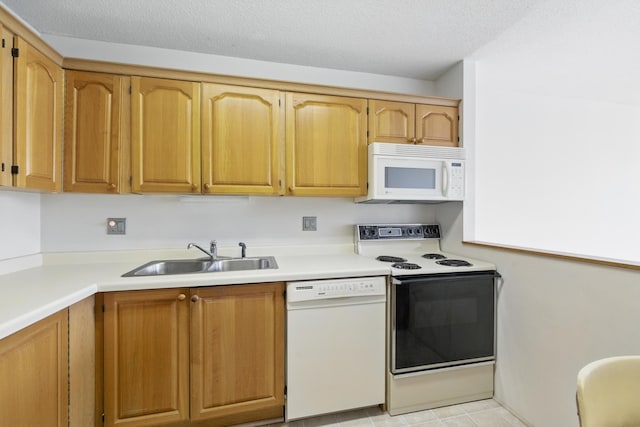 1425 28th St Unit 201, Minneapolis, MN 55408 - kitchen featuring white appliances, a sink, light countertops, and brown cabinetry