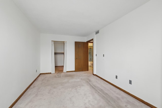1425 28th St Unit 201, Minneapolis, MN 55408 - unfurnished bedroom with baseboards, light colored carpet, a spacious closet, and a closet