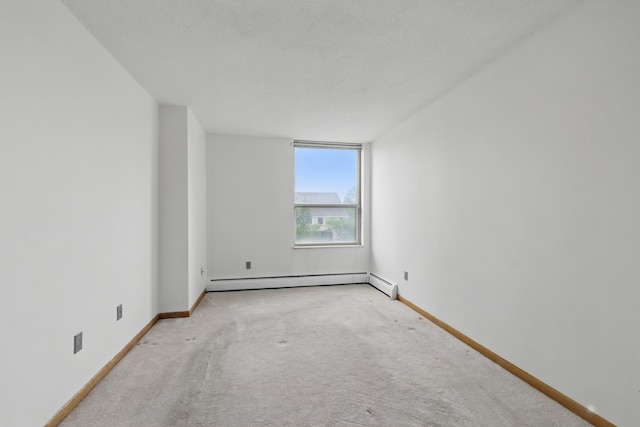 1425 28th St Unit 201, Minneapolis, MN 55408 - empty room featuring a baseboard heating unit, carpet, and baseboards