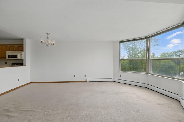 1425 28th St Unit 201, Minneapolis, MN 55408 - spare room featuring a chandelier, light colored carpet, healthy amount of natural light, and baseboards