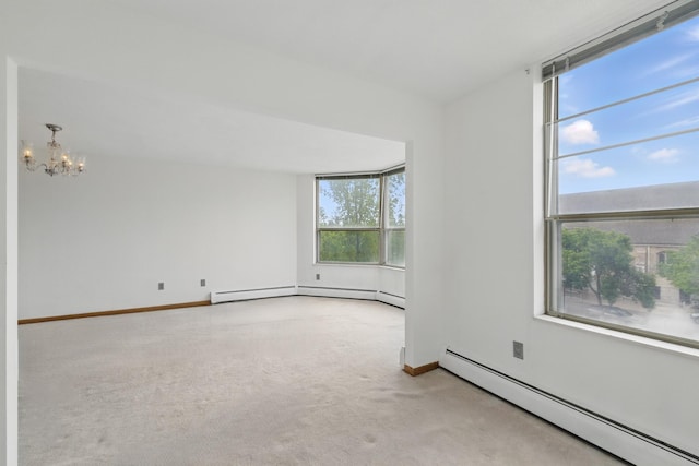 1425 28th St Unit 201, Minneapolis, MN 55408 - spare room with baseboard heating, a chandelier, carpet flooring, and baseboards
