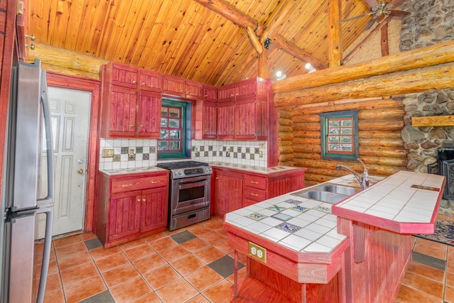 3547 Norway Ln, Ely, MN 55731 - kitchen featuring tile countertops, appliances with stainless steel finishes, a sink, wooden ceiling with exposed beams, and log walls