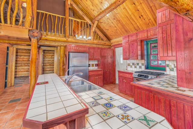 3547 Norway Ln, Ely, MN 55731 - kitchen with tile countertops, stainless steel appliances, a sink, reddish brown cabinets, and wooden ceiling with exposed beams