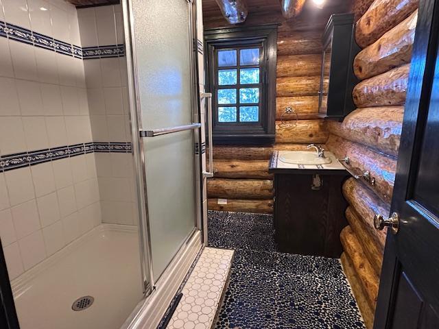 3547 Norway Ln, Ely, MN 55731 - bathroom with log walls, vanity, and a shower stall