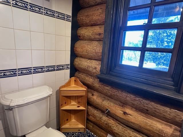 3547 Norway Ln, Ely, MN 55731 - bathroom with log walls, toilet, and tile walls