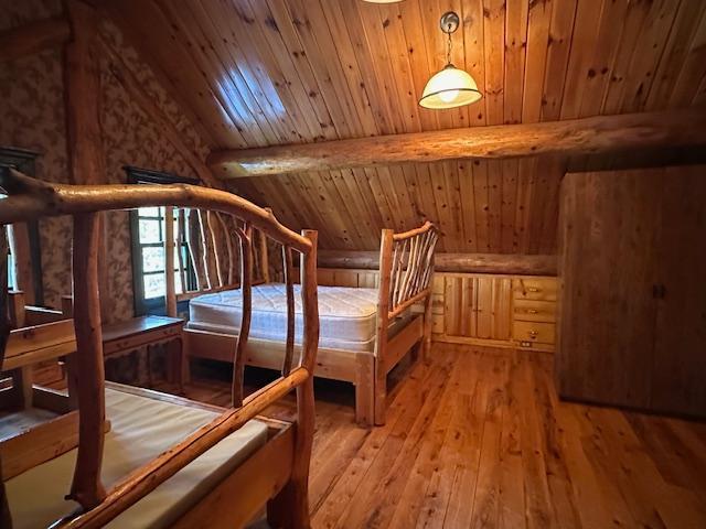 3547 Norway Ln, Ely, MN 55731 - unfurnished bedroom featuring wood ceiling, rustic walls, and light wood finished floors