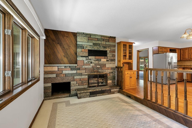 829 Cummings Ln, Saint Cloud, MN 56301 - unfurnished living room featuring a stone fireplace and baseboards