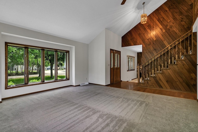829 Cummings Ln, Saint Cloud, MN 56301 - unfurnished living room with carpet flooring, baseboards, stairway, and high vaulted ceiling