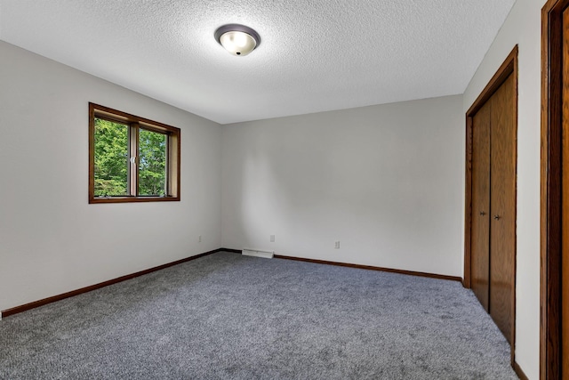 829 Cummings Ln, Saint Cloud, MN 56301 - unfurnished bedroom featuring carpet flooring, a textured ceiling, and baseboards