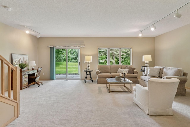 8910 Hilloway Rd, Eden Prairie, MN 55347 - living room featuring track lighting, a textured ceiling, carpet floors, and stairs